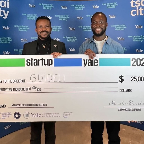 black men holding a large check